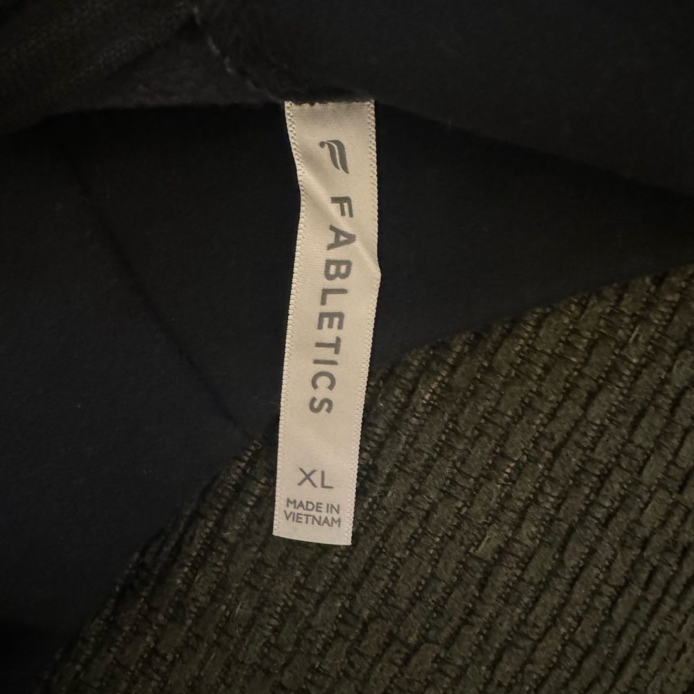 Fabletics sweatshirt. Zipper goes in the back.